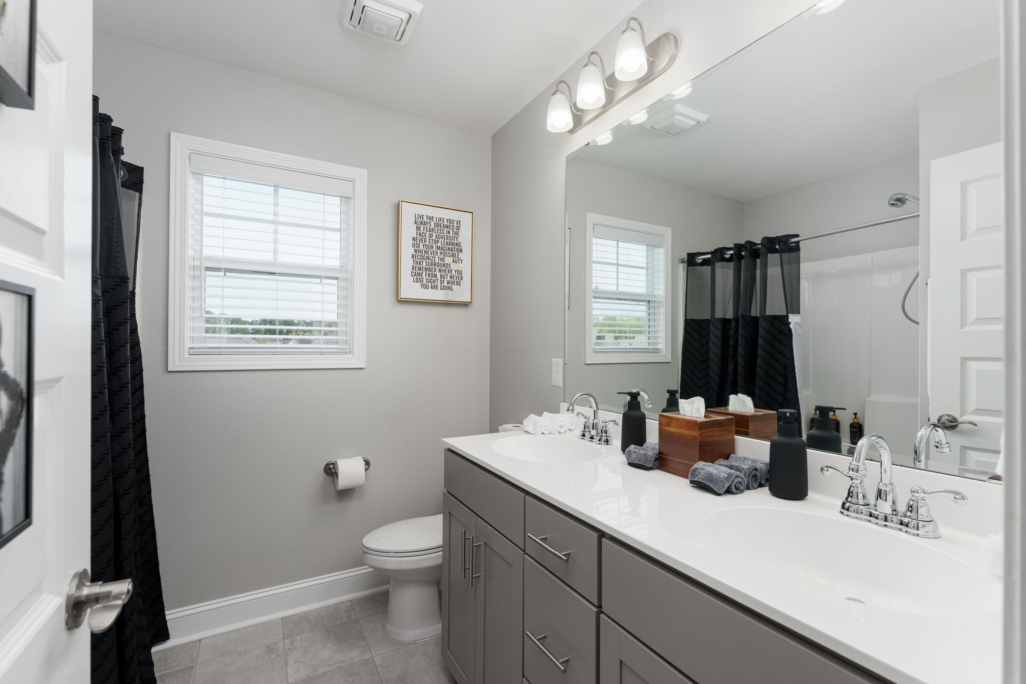Upstairs guest bathroom with double-sink vanity